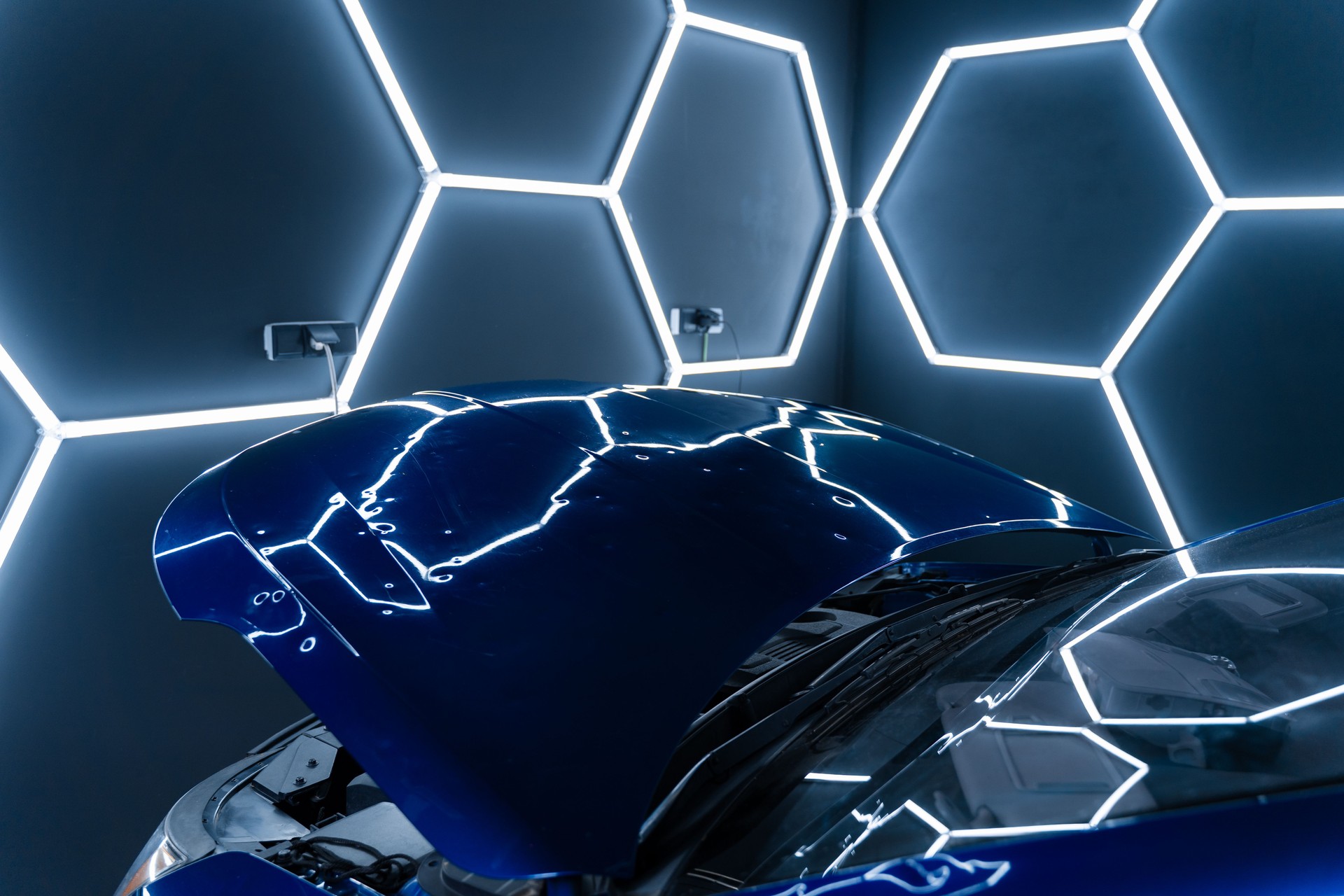 PDR lights reveal damage for accurate dent detection and assessment. Car panel shows multiple dents under PDR lighting, used in paintless dent repair to expose imperfections.